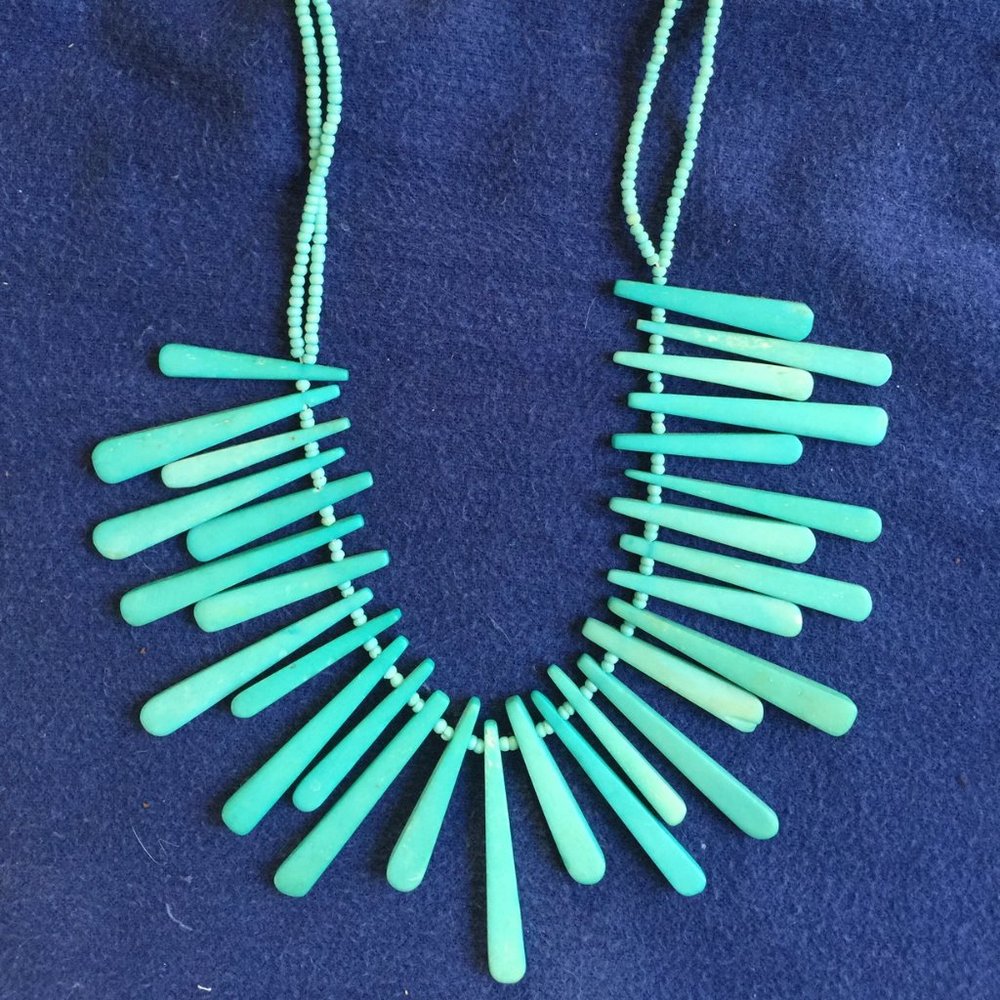 Turquoise colored carved bone necklace